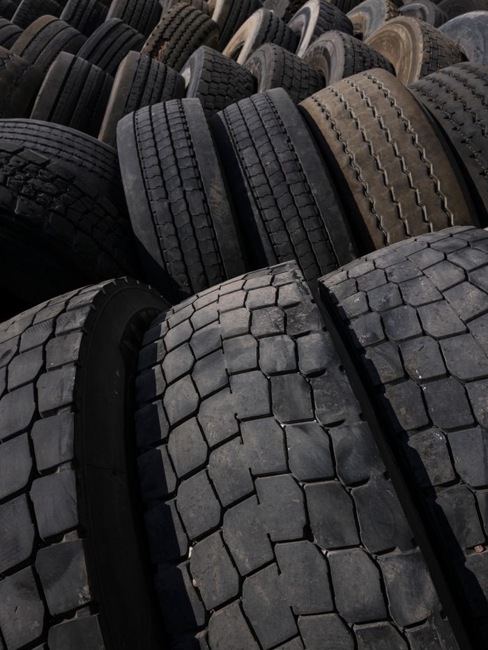 Close-up view of piled used tires at an industrial recycling plant emphasizing sustainability.